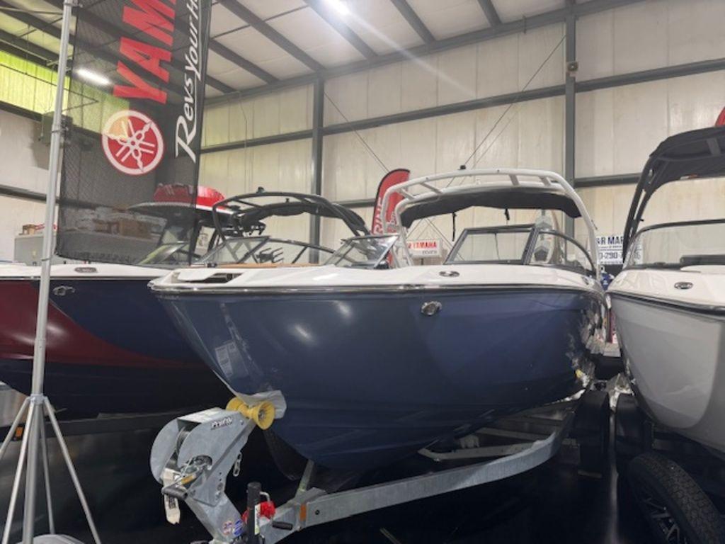 Yamaha Boats 252S 2025 Yamaha Boats 252S displayed indoors, blue hull, on a trailer.
