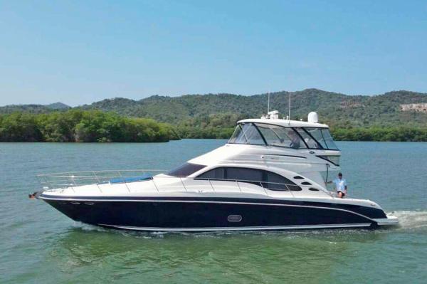 Sea Ray Sedan Bridge 2005 Sea Ray Sedan Bridge yacht cruising on a scenic lake.