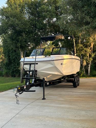 Nautique Super Air G23 2022 Nautique Super Air G23 boat on trailer, parked outdoors.