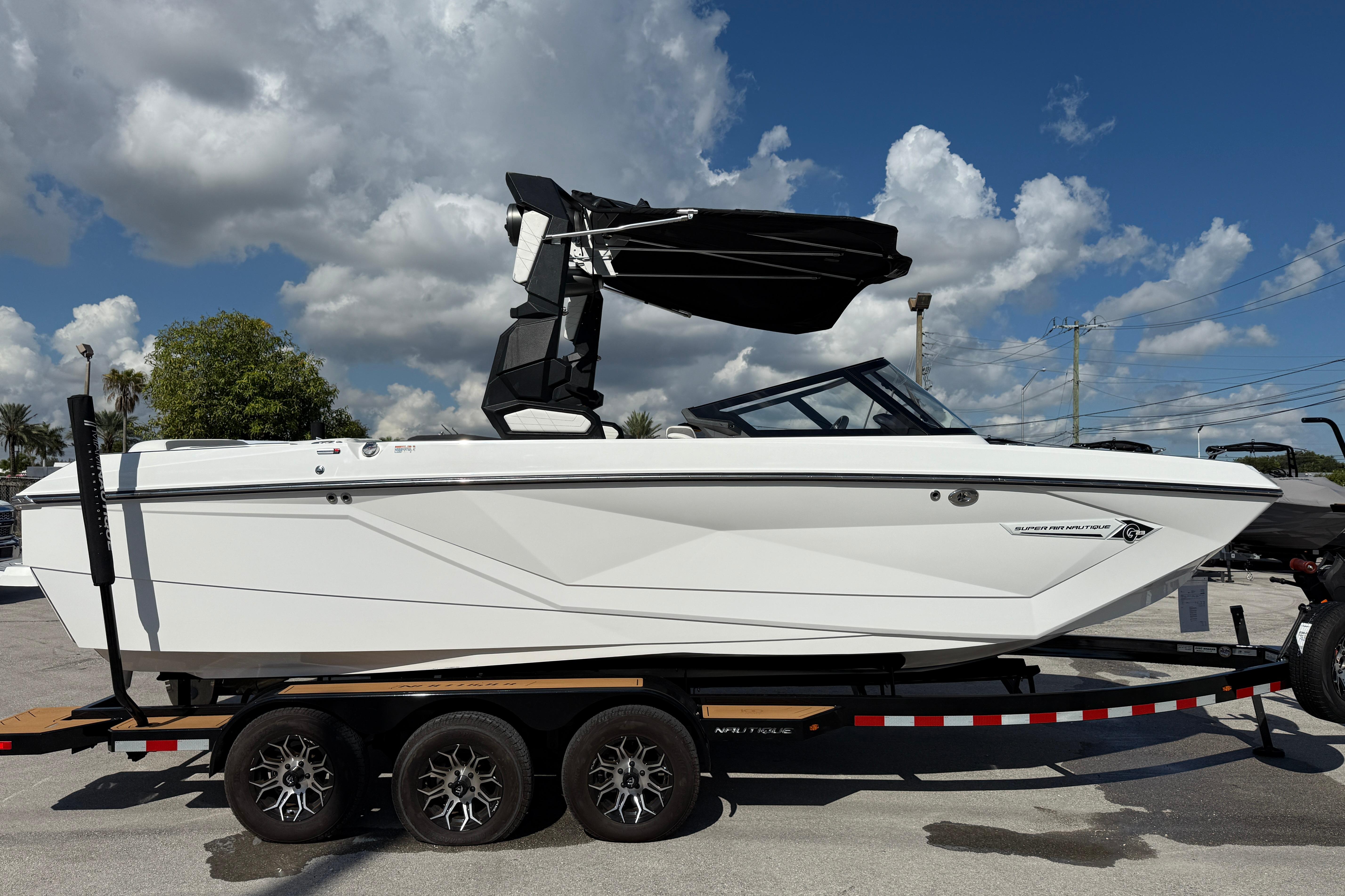 Nautique Super Air Nautique G23 2022 Nautique Super Air Nautique G23 boat on trailer under cloudy sky.