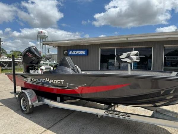 Polar Kraft 195 Pro 2023 Polar Kraft 195 Pro boat on trailer outside Evinrude dealership.