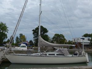 Abbott 36 1986 Abbott 36 sailboat docked at a marina under cloudy skies.