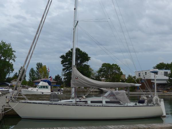 Abbott 36 1986 Abbott 36 sailboat docked at a marina under cloudy skies.