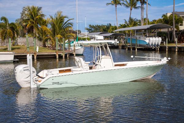 Pathfinder 2700 Open 2023 Pathfinder 2700 Open boat docked in a tropical marina setting.