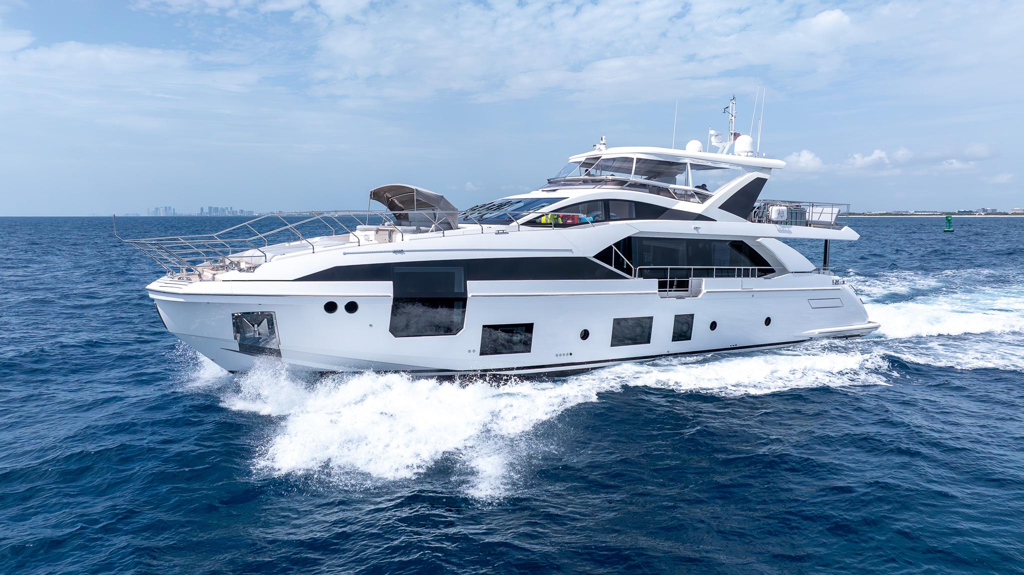 Azimut Grande 27 METRI Luxurious 2021 Azimut Grande 27 METRI yacht cruising on open sea under clear skies.
