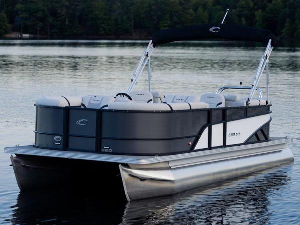 Crest Classic LX 240 SLRC CPT 2023 Crest Classic LX 240 SLRC CPT pontoon boat on a calm lake.