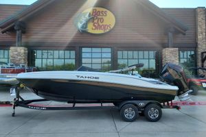 Tahoe T21 2026 Tahoe T21 boat on trailer outside Bass Pro Shops store.