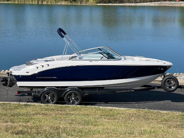 Chaparral 21 SSi 2025 Chaparral 21 SSi boat on trailer by a lake.