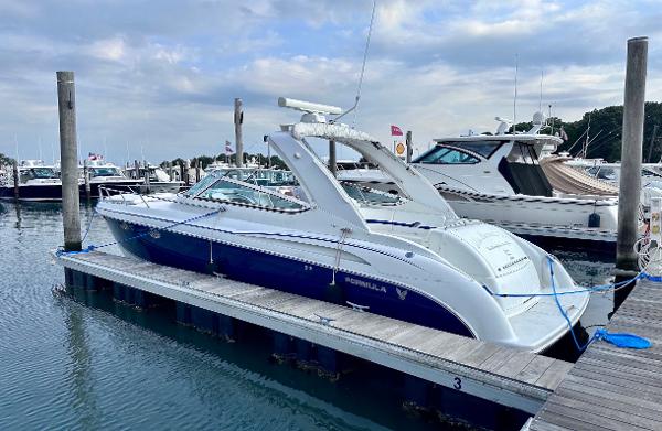 Formula 370 Super Sport 2004 Formula 370 Super Sport boat docked at marina under cloudy sky.