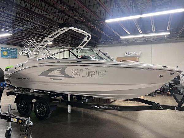 Chaparral 21 Surf 2024 Chaparral 21 Surf boat in a showroom, side view.