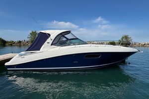 Sea Ray 370 Sundancer 2010 Sea Ray 370 Sundancer boat docked on calm water under clear blue sky.