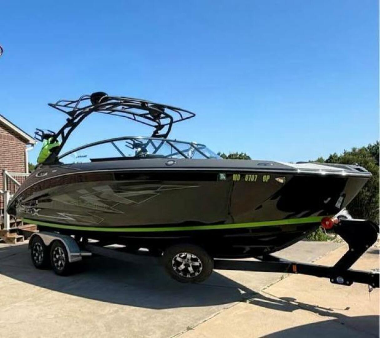 Yamaha Boats 255XD 2021 Yamaha Boats 255XD on trailer, sleek black design, parked outdoors.