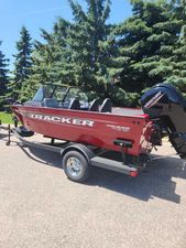 Tracker Pro Guide V-175 Combo 2025 Tracker Pro Guide V-175 Combo boat on trailer, red exterior, parked outdoors.