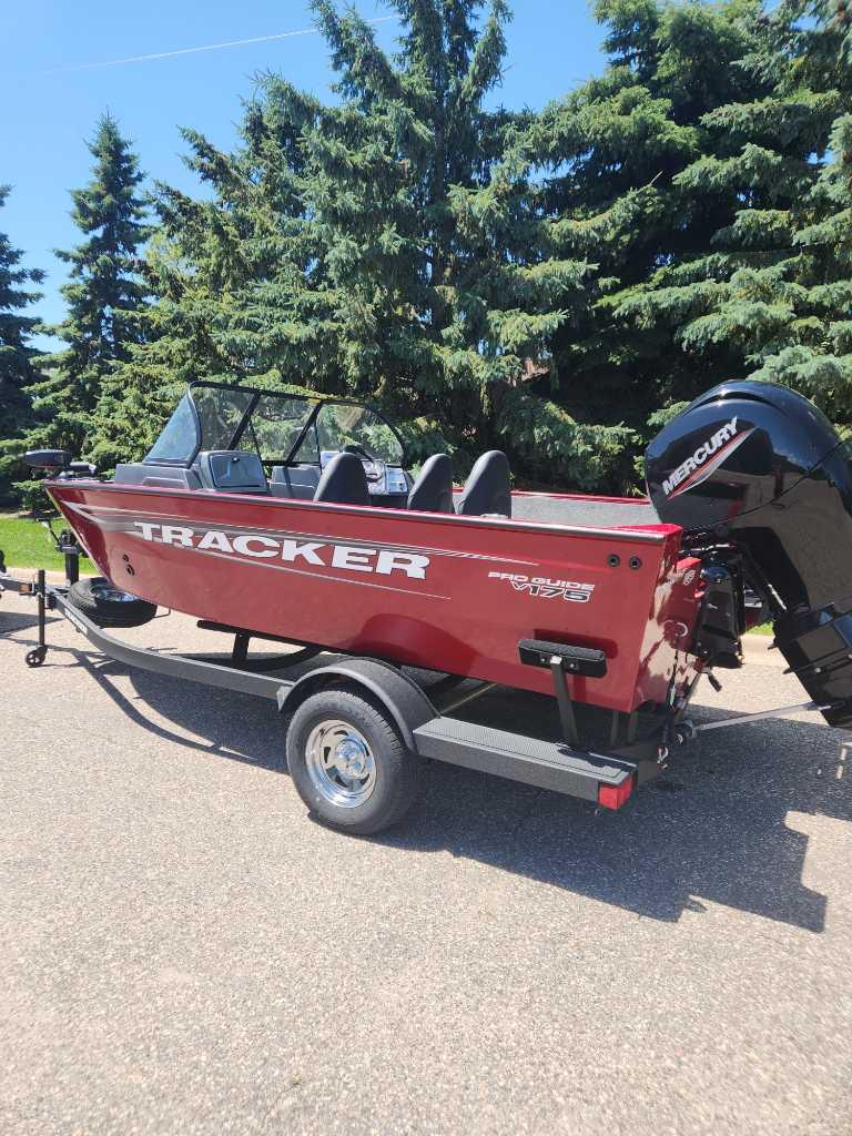 Tracker Pro Guide V-175 Combo 2025 Tracker Pro Guide V-175 Combo boat on trailer, red exterior, parked outdoors.