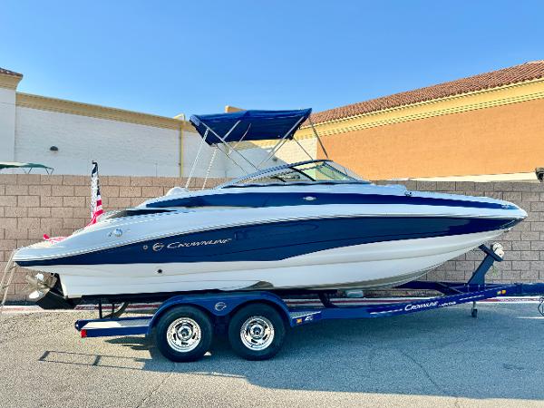 Crownline Eclipse E2 2016 Crownline Eclipse E2 boat on trailer, blue and white design, parked outdoors.
