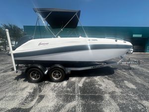 Hurricane SunDeck Sport 192 RL OB 2021 Hurricane SunDeck Sport 192 RL OB boat on trailer, parked outdoors under clear sky.