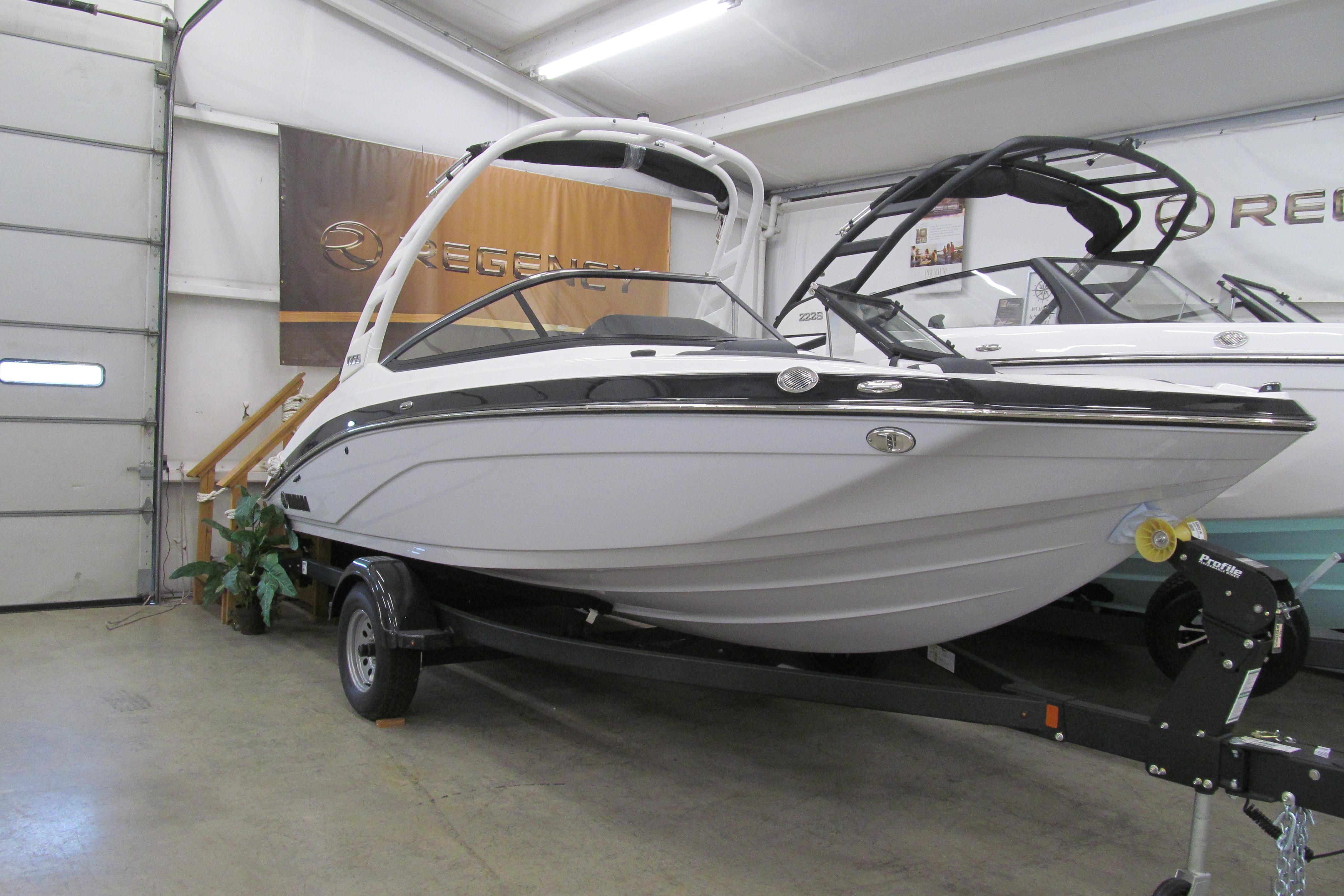 Yamaha Boats 195S 2025 Yamaha Boats 195S on trailer in showroom, sleek design, white hull.