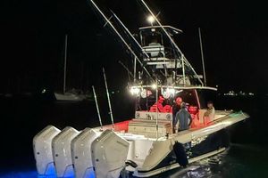 HCB 42 SIESTA RE-POWERED 2014 HCB 42 SIESTA RE-POWERED boat at night with illuminated deck and multiple engines.