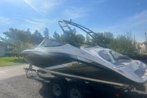 Yamaha Boats AR210 2019 Yamaha AR210 boat on trailer under clear blue sky.