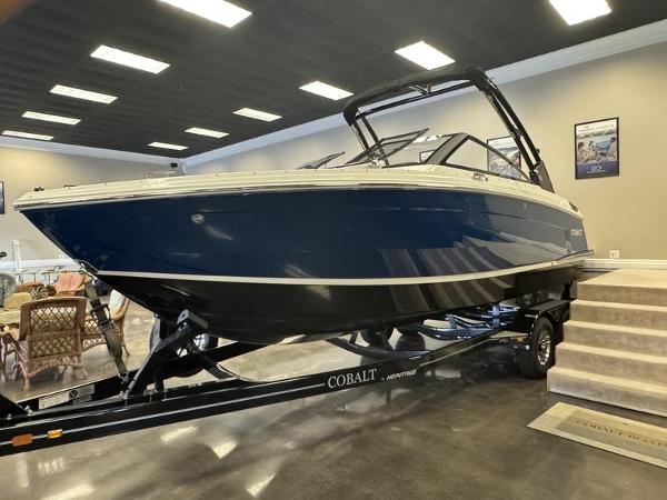 Cobalt R6 2025 Cobalt R6 boat on trailer in showroom, blue and white design.