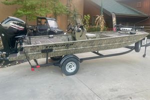 Tracker Grizzly 1860 CC 2026 Tracker Grizzly 1860 CC boat with Mercury engine on trailer, outdoors.