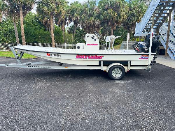 Dream Boats C-18 2013 Dream Boats C-18 on trailer, parked outdoors near palm trees.