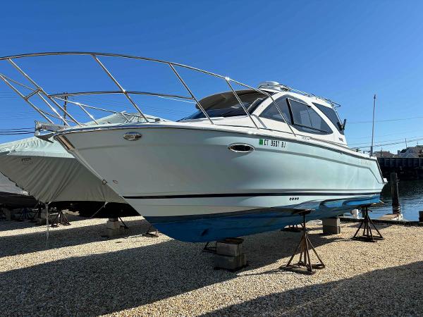 Cutwater C-242 Sport Coupe 2017 Cutwater C-242 Sport Coupe boat on stands, clear sky background.