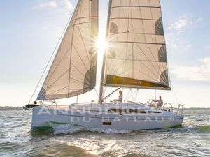 Hanse 348 2024 Hanse 348 sailboat gliding on water with sunlit sails.