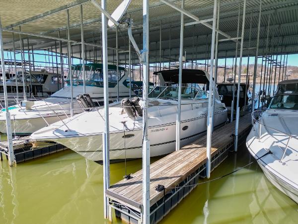 Cruisers Yachts 370 Express 2005 Cruisers Yachts 370 Express docked in a marina under a covered structure.