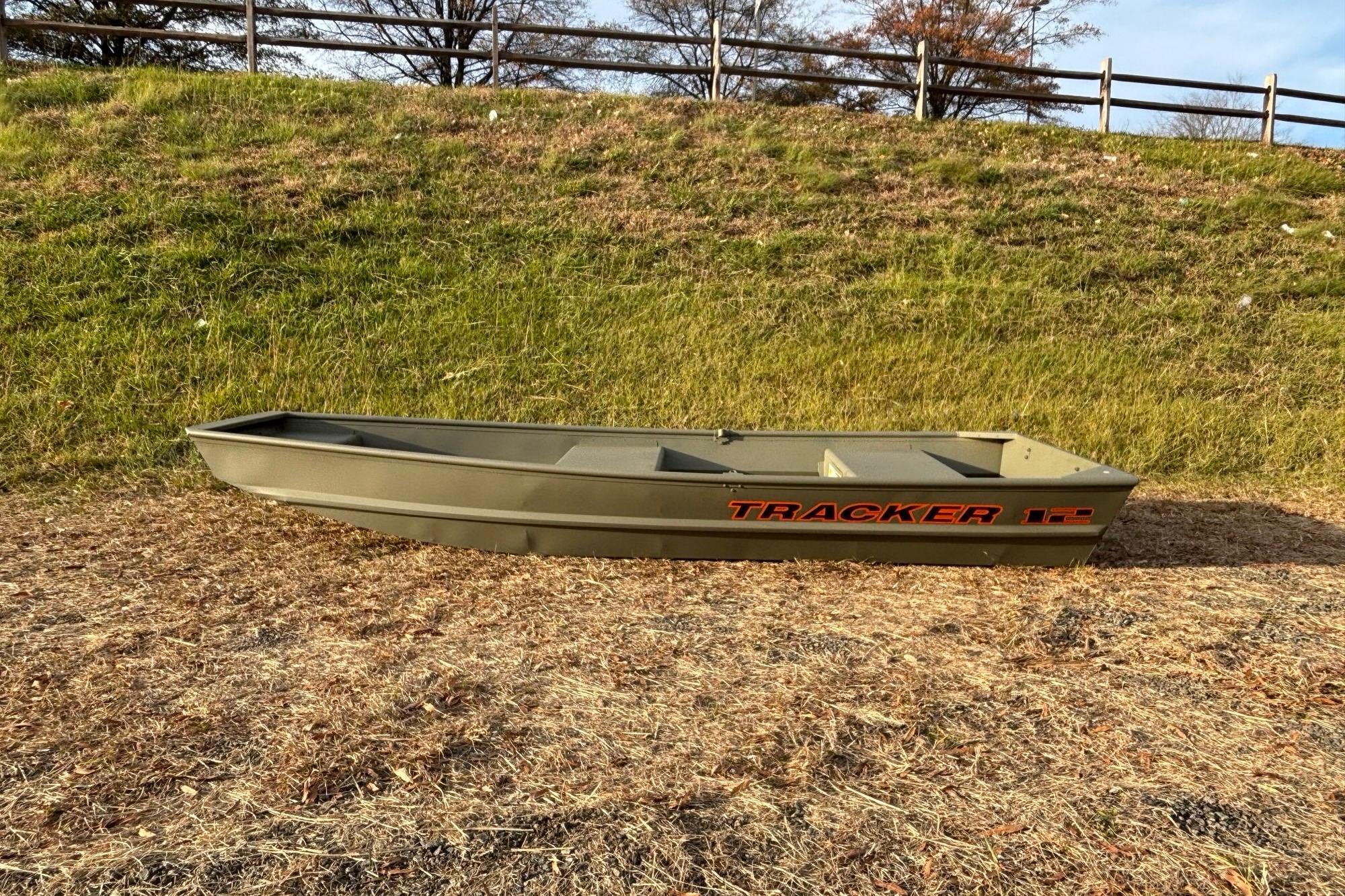 Tracker Grizzly 12 Jon 2026 Tracker Grizzly 12 Jon boat on grassy terrain, side view.