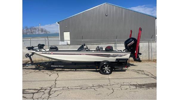 Ranger RT198P 2018 Ranger RT198P boat on trailer, parked near a metal building.