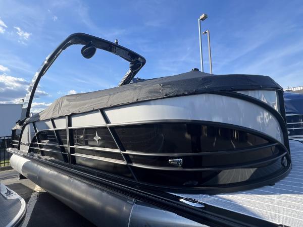 Berkshire 23 RFX DC STS3-93 2024 Berkshire 23 RFX DC STS3-93 pontoon boat with black cover, under blue sky.