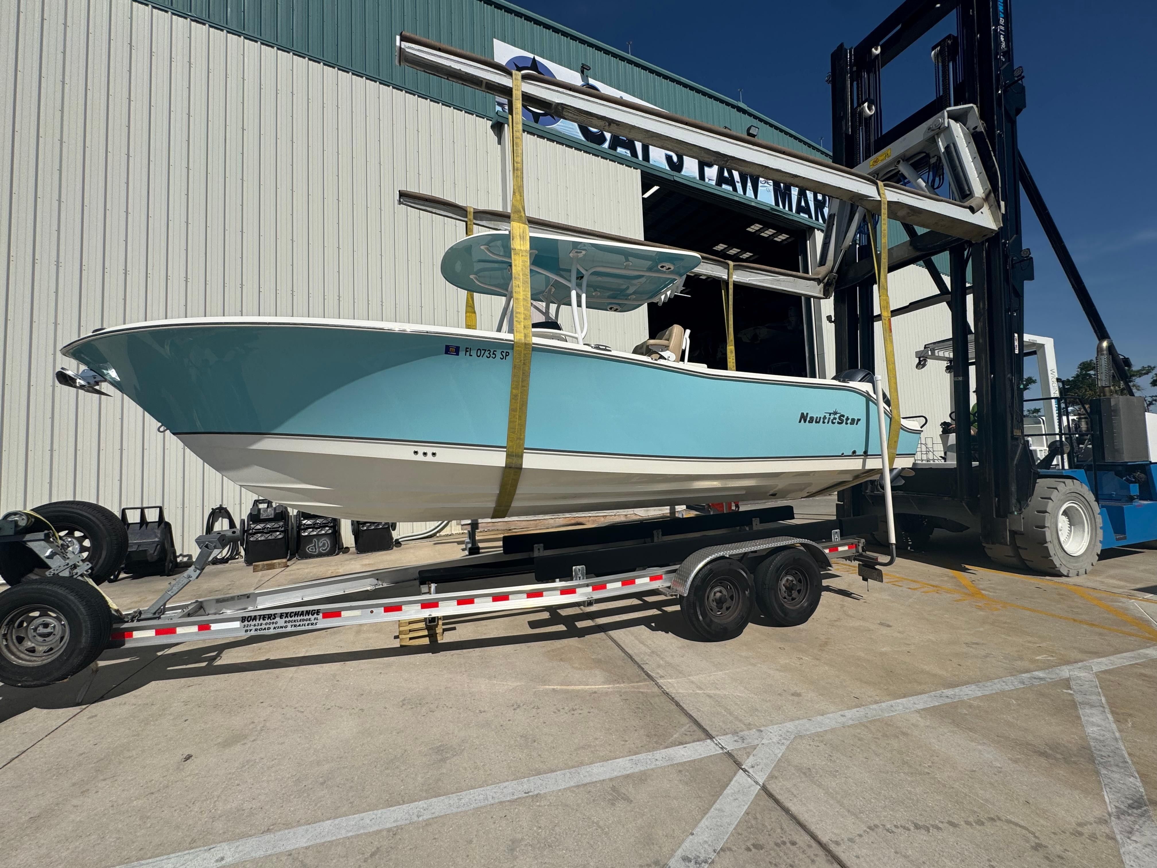 NauticStar 28 XS Offshore 2019 NauticStar 28 XS Offshore boat on trailer at marina.
