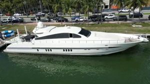 Leopard 27m Luxury Leopard 27m yacht from 2005 docked by palm-lined waterfront.