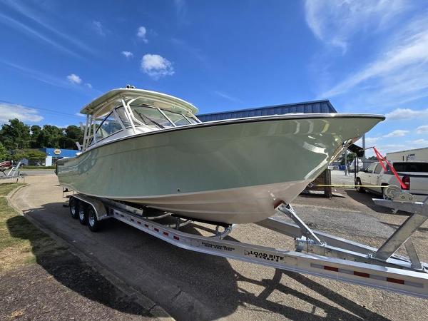 Grady-White Freedom 307 2024 Grady-White Freedom 307 boat on trailer under clear blue sky.