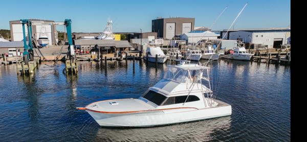 Custom Carolina Buddy Davis 1984 Custom Carolina Buddy Davis boat docked at a marina.