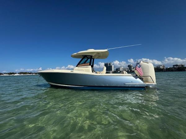 Chris-Craft Catalina 24 2024 Chris-Craft Catalina 24 boat on clear water with city skyline in background.