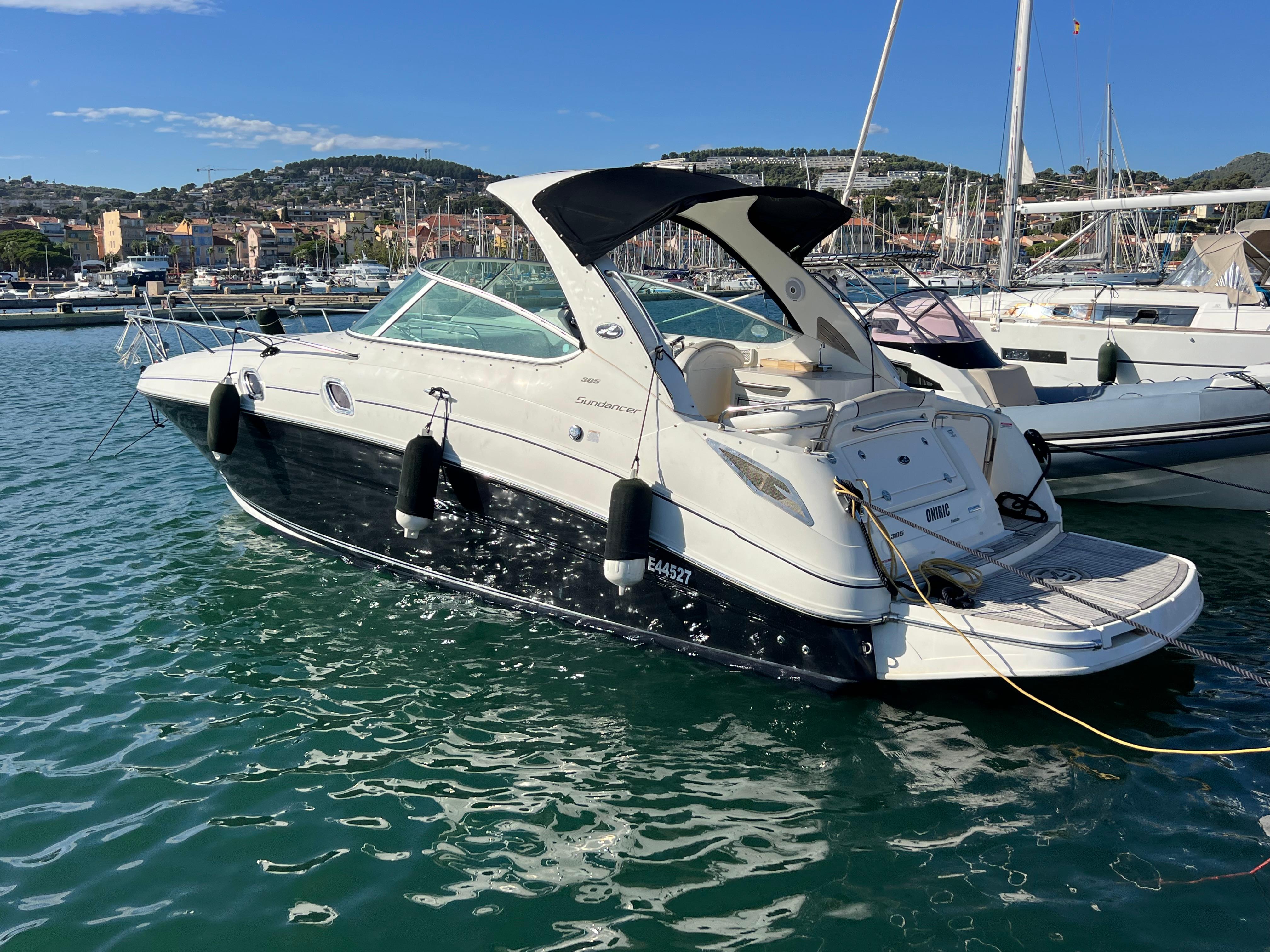 Sea Ray 305 Sundancer 2011 Sea Ray 305 Sundancer boat docked in a marina, clear sky background.
