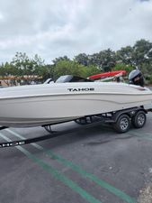 Tahoe T21 2025 Tahoe T21 boat on trailer in parking lot, overcast sky.