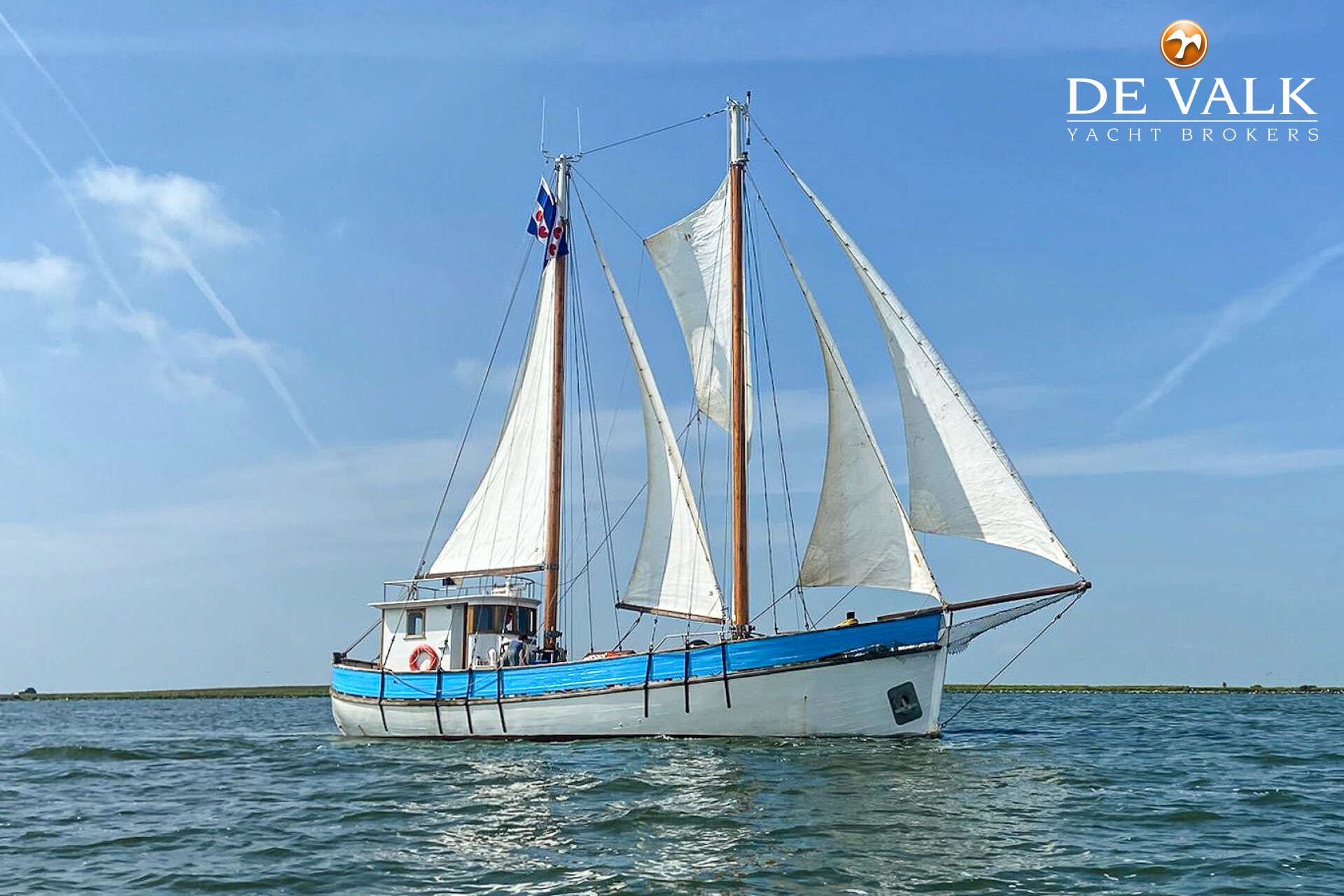 Noorse Zeilkotter 1945 Noorse Zeilkotter sailboat on open water under clear blue sky.