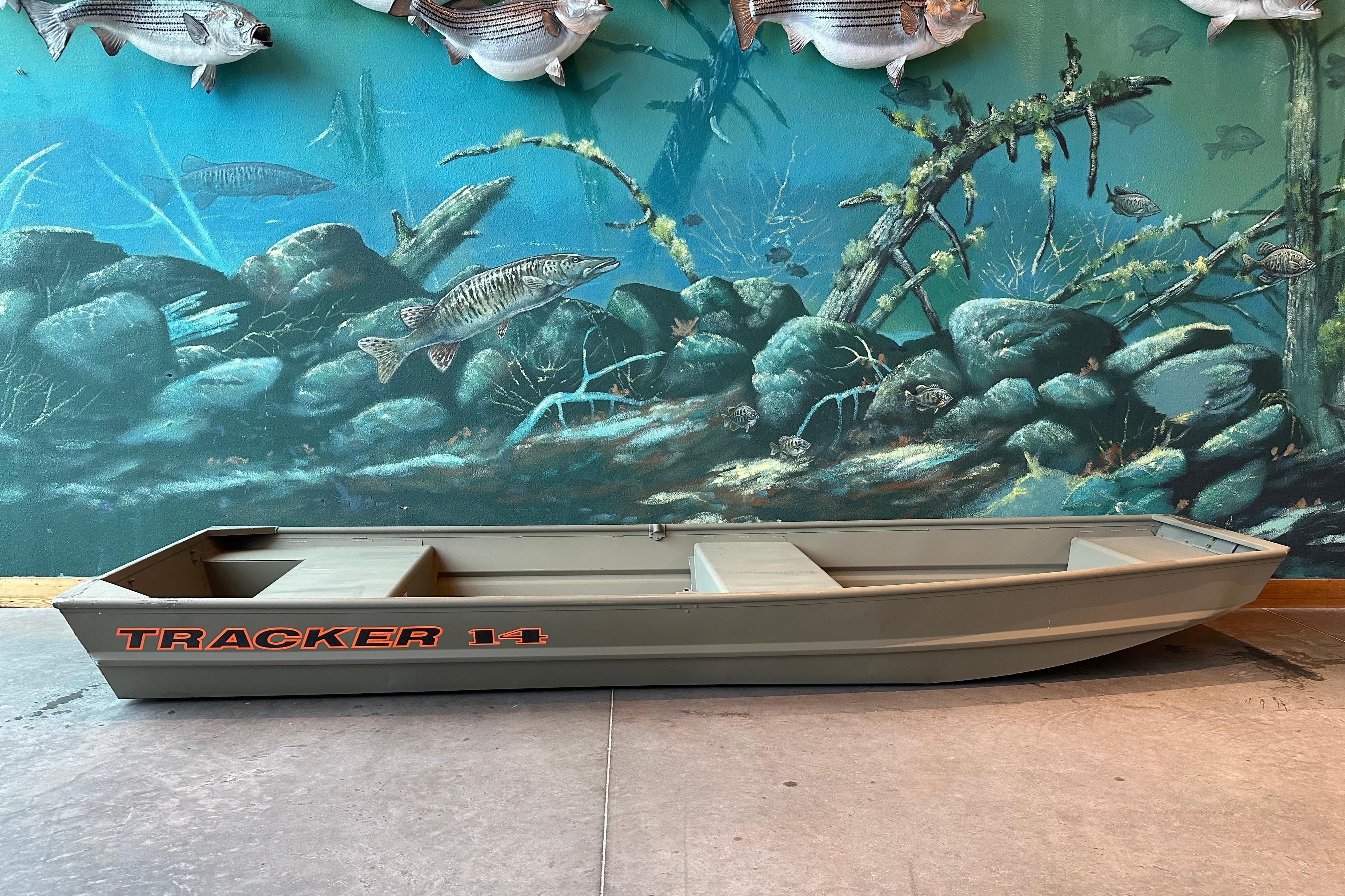 Tracker Grizzly 14 Jon 2026 Tracker Grizzly 14 Jon boat displayed against aquatic-themed mural.