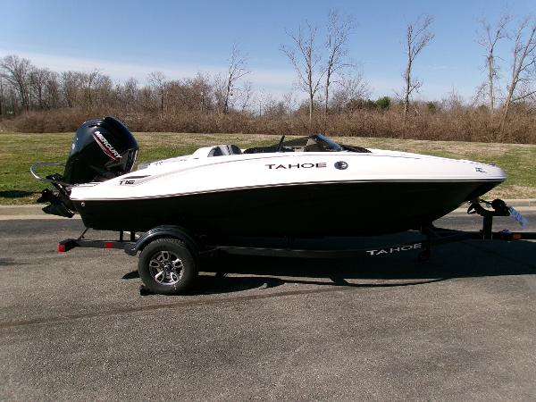 Tahoe T16 2025 Tahoe T16 boat on trailer, parked outdoors, showcasing sleek design and modern features.