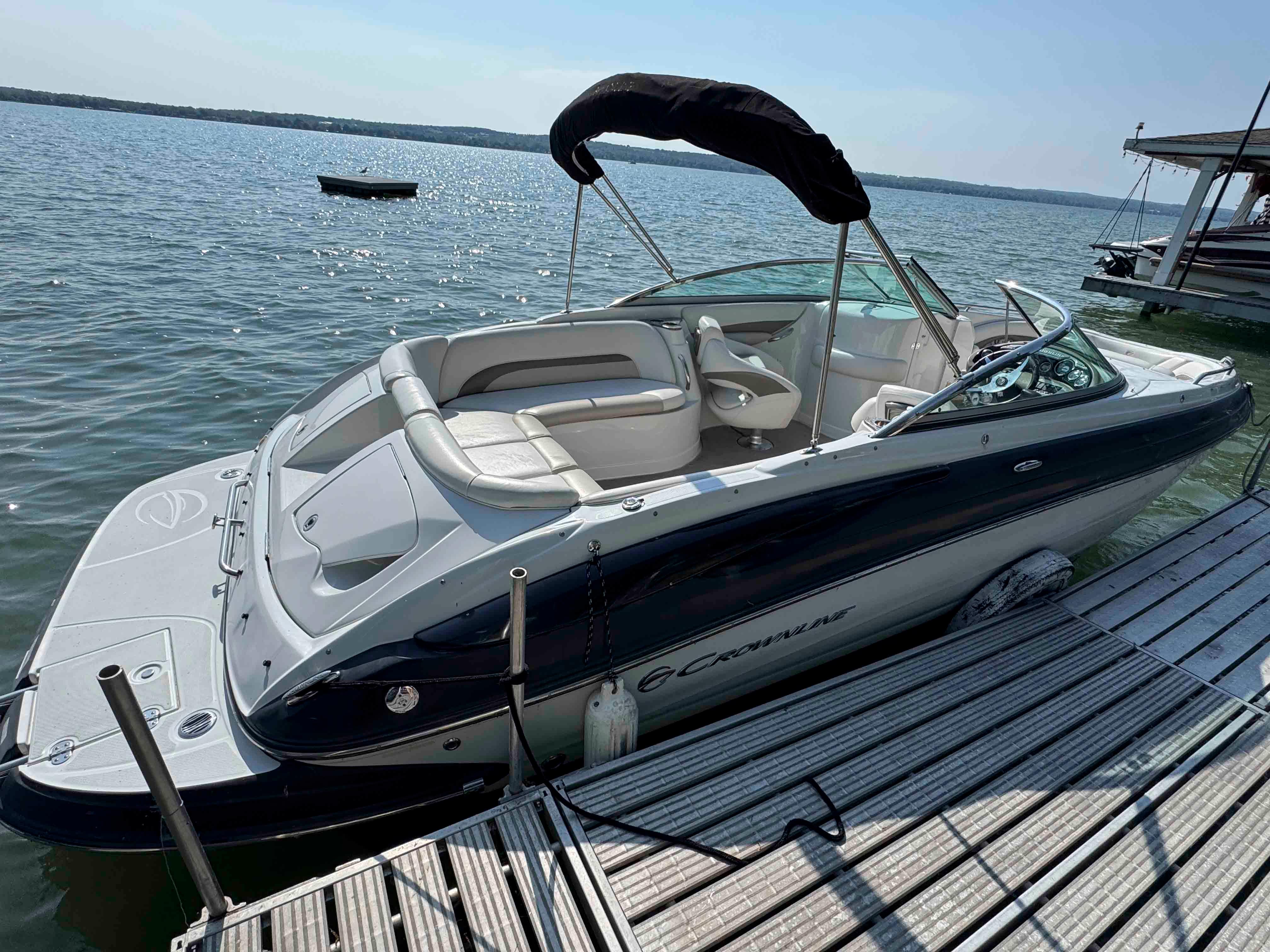 Crownline 240 LS 2010 Crownline 240 LS boat docked on a sunny lake.