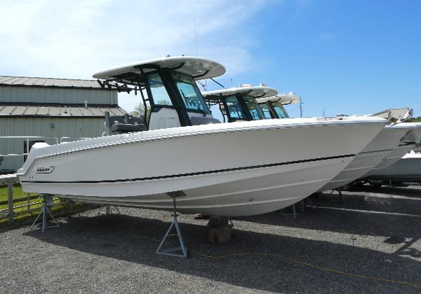 Boston Whaler 250 Outrage 2025 Boston Whaler 250 Outrage boat displayed on stands outdoors.