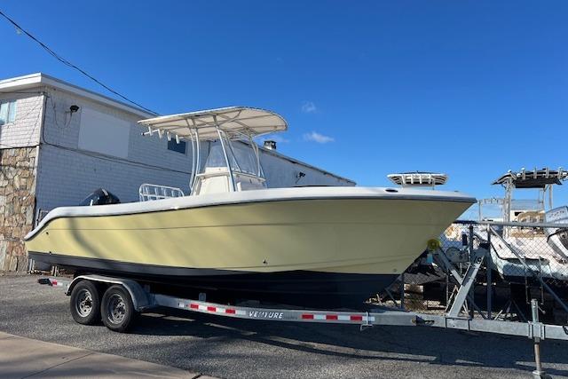 Cobia 237 Center Console 2020 Cobia 237 Center Console boat on trailer, parked outdoors under clear blue sky.