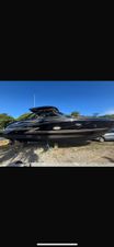 Formula 350 Crossover Bowrider 2018 Formula 350 Crossover Bowrider, black exterior, parked on land, clear blue sky.