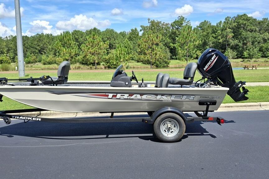 Tracker Pro 170 2026 Tracker Pro 170 boat on trailer, parked outdoors, with Mercury outboard motor.