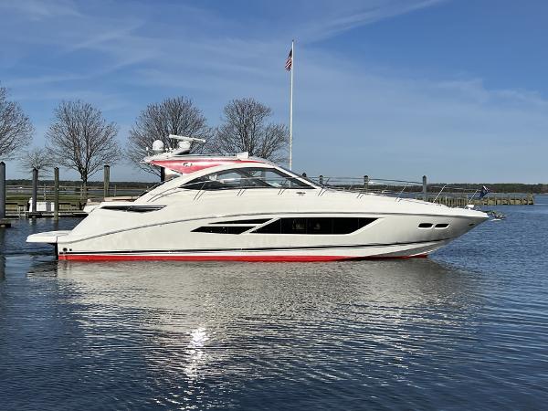 Sea Ray 510 Sundancer 2016 Sea Ray 510 Sundancer yacht docked on calm water under clear blue sky.
