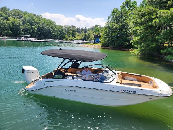 Hurricane SunDeck 2600 OB 2024 Hurricane SunDeck 2600 OB boat cruising on a scenic lake.