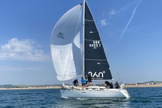 Beneteau First 33.7 Sailing yacht Beneteau First 33.7, 2001 model, cruising on open water under clear skies.